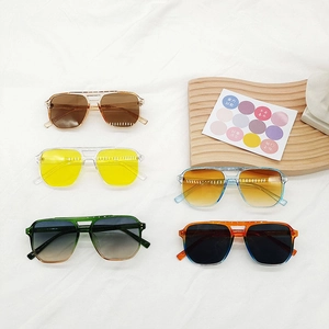 Square oversized ocean lens sunglasses in five assorted frame colors on a white fabric base