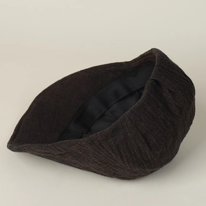 Close-up of the vintage brown linen flat cap showing the inner lining and sweatband