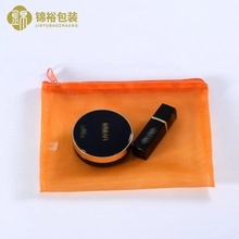 Translucent orange mesh pouch for cosmetics with smooth plastic zipper closure