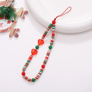 Close-up of handmade beaded phone strap with red heart and Christmas theme beads