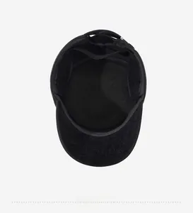 Detail view of the black wool flat cap interior showing high-quality lining and stitching