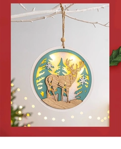 Detail showing lighted wooden Christmas pendant with reindeer carving and LED glow