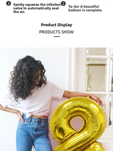 Detailed view of large 40 inch metallic gold number 2 balloon held by a model