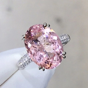 Elegant oval pink gemstone ring with white gold plated band and pavé set side stones