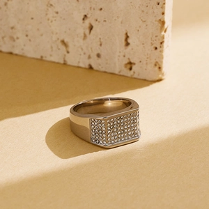Macro shot of silver titanium ring featuring a rectangular pave-set zircon centerpiece