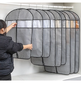 Detail of breathable houndstooth garment cover with transparent window and side zipper
