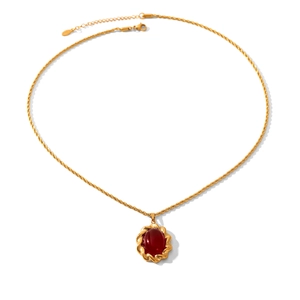 French vintage titanium steel necklace with oval red gemstone pendant on white background