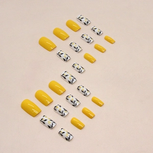 Mid-length square yellow press-on nails with floral leaf silhouette patterns