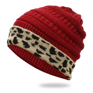 Burgundy knitted beanie for women featuring a leopard print cuff for winter warmth