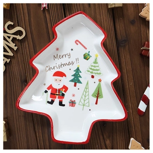Close-up of a Christmas tree shaped ceramic plate with festive Santa and gift box patterns