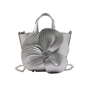 Silver bucket bag with 3D flower decoration and metallic chain strap for women