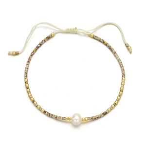 Handmade bohemian beaded bracelet with white pearl and adjustable woven rope on white background