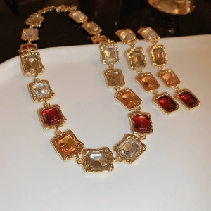 Vintage gold necklace and earrings set with amber and red rectangular gemstones