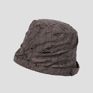 Detailed view of the distressed knit texture and hole craft on the vintage bucket hat