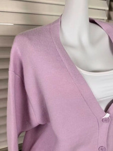 Detail of lavender V-neck knit cardigan showing soft wool texture and buttons