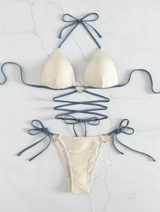 Flat lay of textured drawstring bikini with heart-shaped metal rings and wrap ties