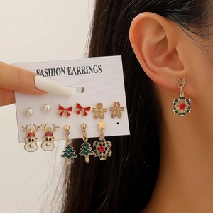 Detailed set of festive Christmas earrings featuring gingerbread man and reindeer charms