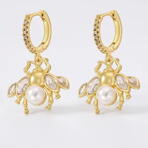 Elegant gold brass bee drop earrings featuring white pearls and marquise cubic zirconia