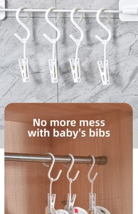White multi-functional S-hook clip for organizing towels and baby bibs on a closet rod