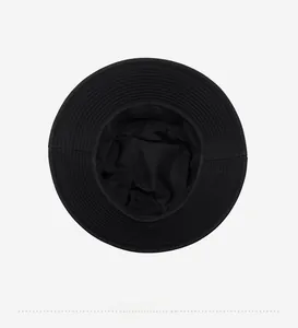 Interior view of black cotton bucket hat showing reinforced stitching and washing label