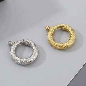 Detailed view of gold and silver snake pattern round clasps for DIY jewelry making