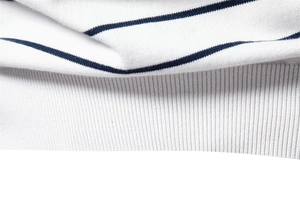 Detailed macro view of navy and white striped knit fabric with ribbed cuff texture