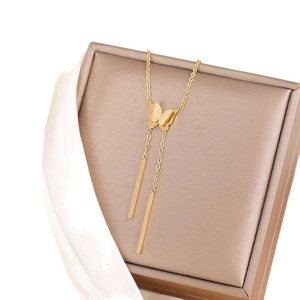 Titanium steel butterfly tassel necklace in gold plating on a premium jewelry box display