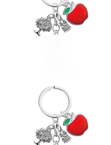 Close-up of engraved metal pendant with teacher appreciation quote and apple charm