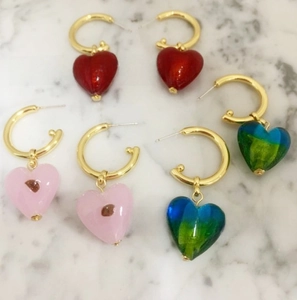 Detailed close-up of handmade glass heart charms and gold-plated hoop earrings set