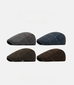 Detail of four vintage herringbone wool flat caps in diverse retro patterns and colors
