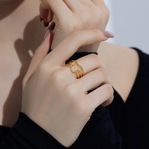 Close-up of a layered gold ring featuring sparkling moon and star zircon embellishments