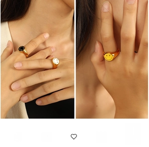 Detailed view of exaggerated smile face rings in 18K gold plated steel and enamel finish
