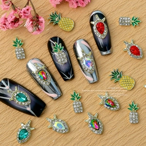 Detail of alloy nail charms with colorful rhinestones and vintage pineapple shapes