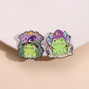 Enamel wizard frog pins with magic hats and mushrooms on a clean white display pedestal