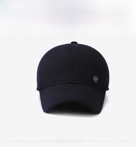Detail view of the navy wool baseball cap with a metal SPORT tag and thick winter fabric