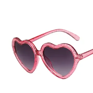 Pink heart-shaped glitter sunglasses for girls with grey gradient lenses and stylish frames