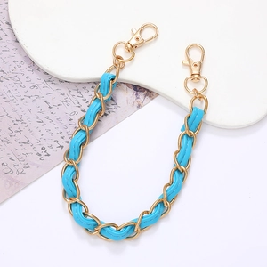 Detailed view of blue leather woven metal chain strap with gold lobster claw clasps