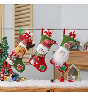 Close-up of knit Christmas stockings with reindeer, snowman, and Santa Claus patterns