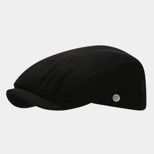 Classic black cotton newsboy cap with silver metal emblem in a 45-degree side view profile
