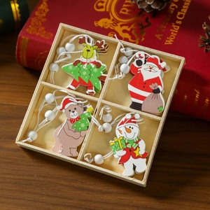 Close-up of wooden Santa, snowman, bear, and reindeer ornaments in a four-grid box