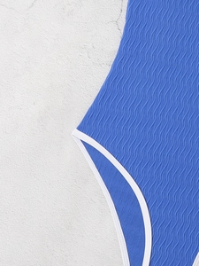 Detail of blue backless swimsuit featuring ribbed texture and white contrast stitching