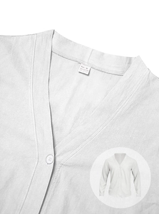 Close-up of white cotton cardigan collar with M size label and fabric texture detail