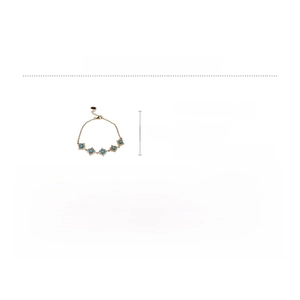 Close-up of golden link bracelet with four square blue zircon stones on a white background