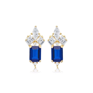 Detail of luxury gold stud earrings featuring deep blue rectangular zircon stones and crystals