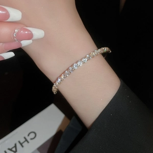 Close-up of sparkling tennis bracelet with round-cut crystals on a polished silver band
