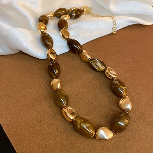 Maillard vintage resin oval bead necklace with gold metal accents on white silk