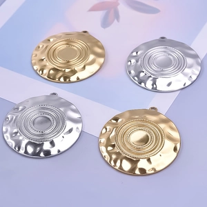 Macro shot of 304 stainless steel round pendants with irregular edges in gold and silver