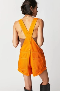 Back view of orange denim overalls featuring cross-back straps and functional rear pockets