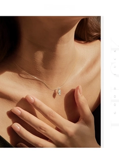 Close-up of a marquise-cut Moissanite pendant on a silver-tone chain necklace
