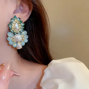 French vintage floral drop earrings with pearls and crystals shown on a female model